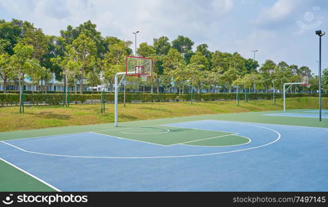 Outdoor open basketball court under sunny sky . Healthy lifestyle sport background .