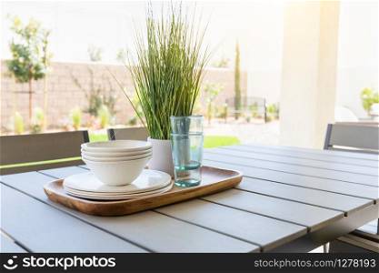 Outdoor Patio Setting with Dishes and Glasses on Tray.