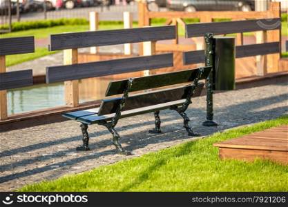 Outdoor photo of bench at park near river