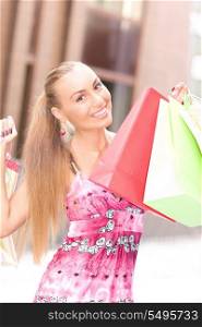 outdoor picture of attractive woman with shopping bags