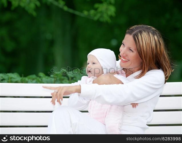outdoor picture of happy mother with baby (focus on faces)