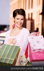 outdoor picture of happy woman with shopping bags