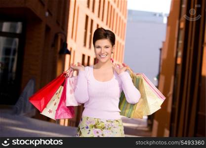 outdoor picture of happy woman with shopping bags