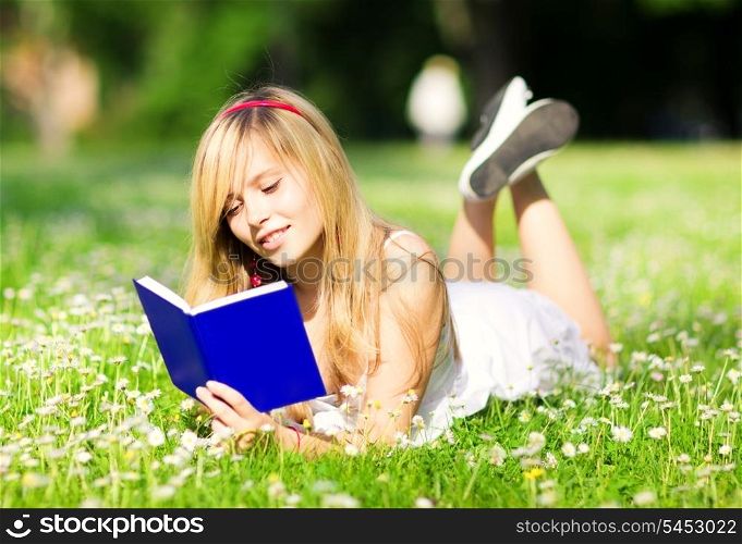 outdoor picture of lovely teenage girl with book