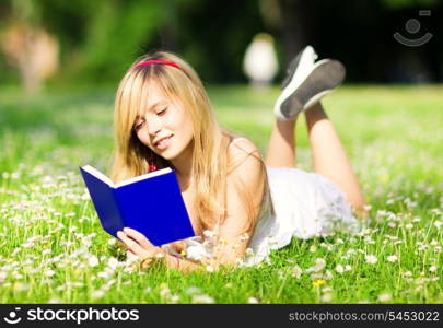 outdoor picture of lovely teenage girl with book