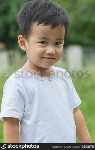 outdoor portrait head shot of asian children smiling face looking with eyes contact to camera
