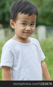 outdoor portrait head shot of asian children smiling face looking with eyes contact to camera