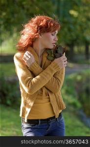 outdoor portrait in the autumn sun of a red haired woman