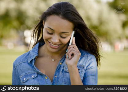 Outdoor portrait of a beautiful African American talking at phone