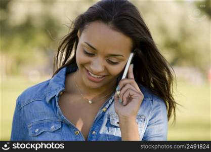 Outdoor portrait of a beautiful African American talking at phone