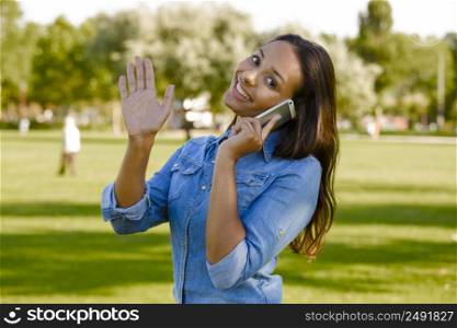 Outdoor portrait of a beautiful African American talking at phone