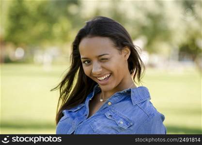 Outdoor portrait of a beautiful African American woman winking