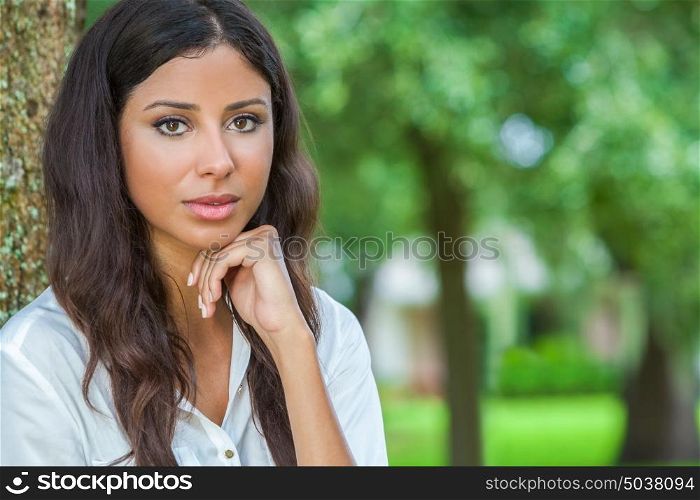 Outdoor portrait of a beautiful thoughtful young female Latina Hispanic woman