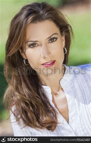 Outdoor portrait of a beautiful young brunette woman in her thirties