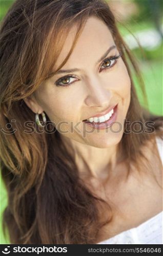 Outdoor portrait of a beautiful young brunette woman in her thirties