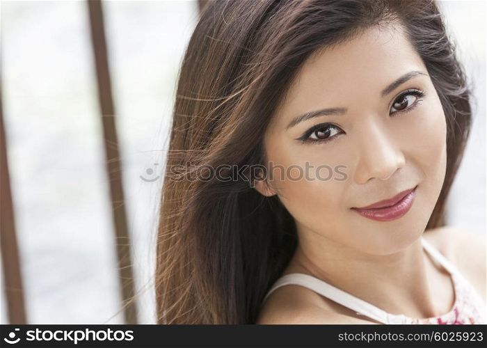 Outdoor portrait of a beautiful young Chinese Asian young woman or girl