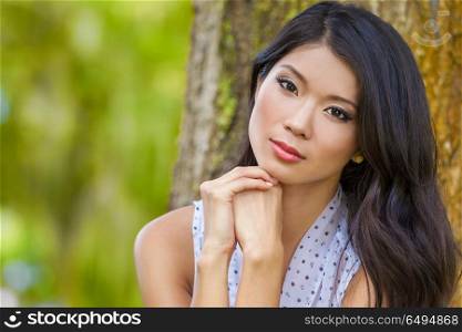Outdoor portrait of a beautiful young Chinese Asian young woman or girl. Beautiful Chinese Asian Young Woman Girl Outside