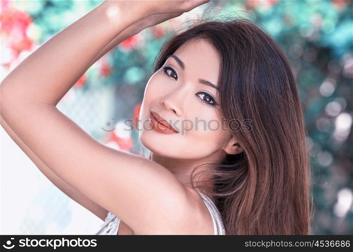 Outdoor portrait of a beautiful young female Chinese Asian young woman or girl