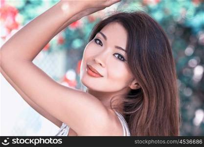 Outdoor portrait of a beautiful young female Chinese Asian young woman or girl