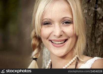 Outdoor portrait of a beautiful young girl laughing