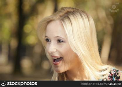 Outdoor portrait of a beautiful young girl laughing