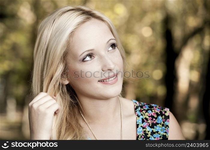 Outdoor portrait of a beautiful young girl smiling
