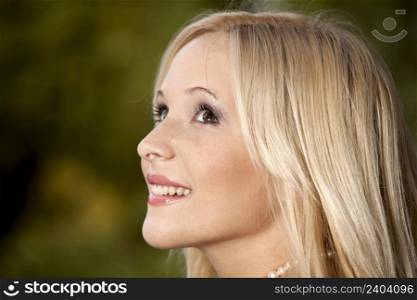 Outdoor portrait of a beautiful young girl smiling