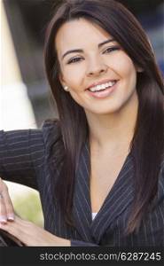 Outdoor portrait of a beautiful young Latina Hispanic business woman or businesswoman smiling