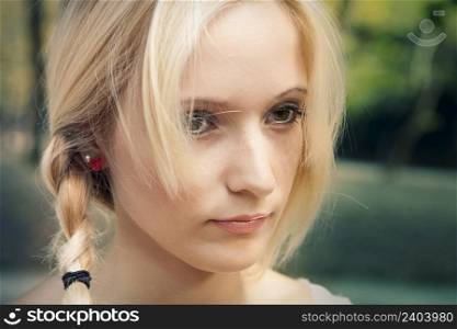 Outdoor portrait of a beautiful young woman in the park