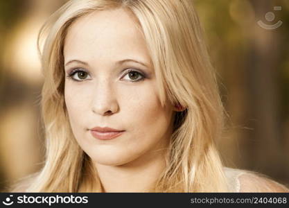 Outdoor portrait of a beautiful young woman in the park