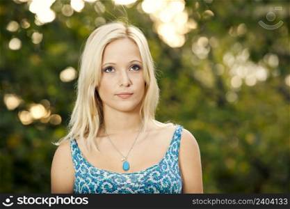 Outdoor portrait of a beautiful young woman in the park
