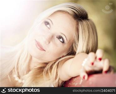Outdoor portrait of a beautiful young woman thinking on something