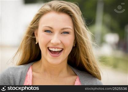 Outdoor portrait of a happy and beautiful teenage girl