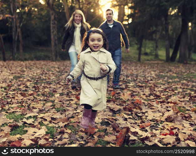 Outdoor portrait of a happy family enjoying the fall season