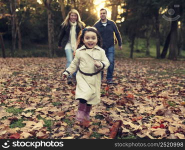 Outdoor portrait of a happy family enjoying the fall season