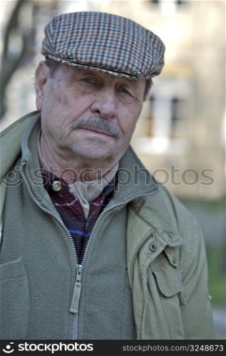 Outdoor portrait of a senior man, europian style.