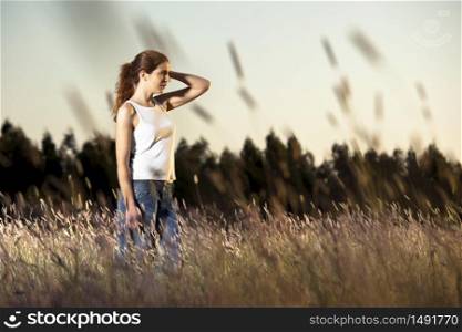 Outdoor portrait of a woman in a meadow on a summer day