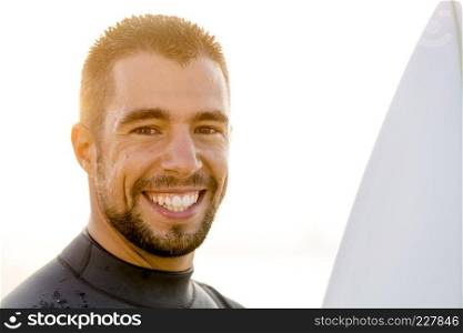 Outdoor portrait of an handsome young surfist smiling
