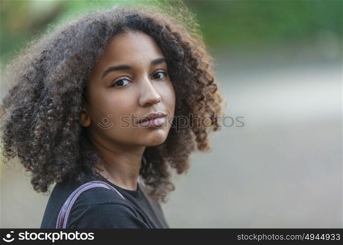 Outdoor portrait of beautiful happy mixed race African American girl teenager female child