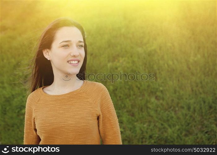 Outdoor portrait of beautiful happy teenager girl laughing under a sunny day