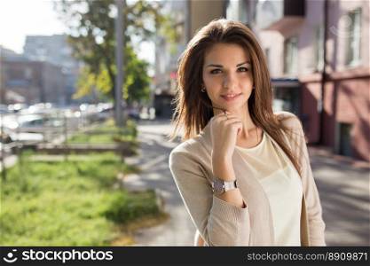 Outdoor portrait of beauty woman with perfect smile standing on the street. Portrait of beauty woman with perfect smile standing on the street and looking at camera.