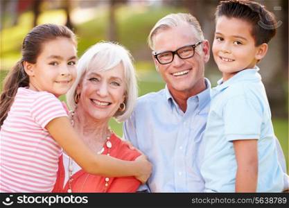 Outdoor Portrait Of Grandparents With Grandchildren In Park