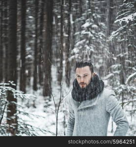 Outdoor portrait of handsome man in coat and scurf. Casual winter fashion