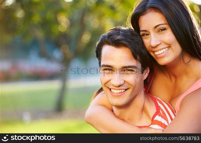 Outdoor Portrait Of Romantic Young Couple In Park