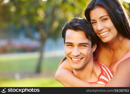 Outdoor Portrait Of Romantic Young Couple In Park