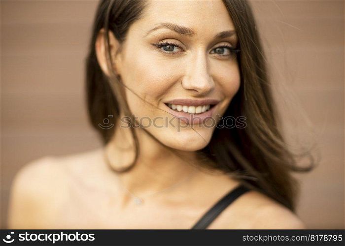 Outdoor portrait of sensual long hair brunette woman