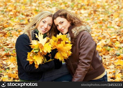outdoor portrait of two young women in autumnal park