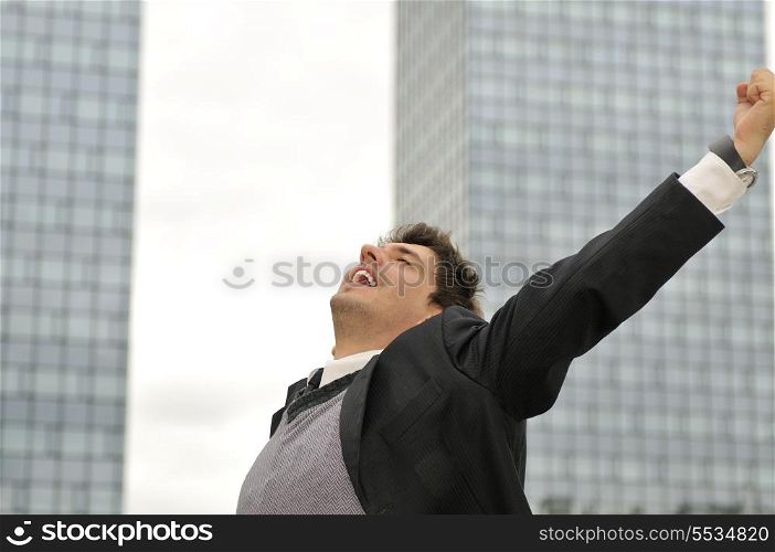 Outdoor portrait of young and happy businessman