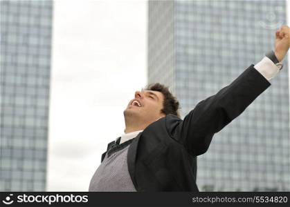 Outdoor portrait of young and happy businessman