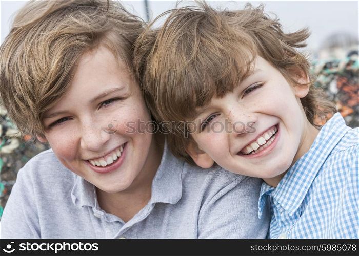 Outdoor portrait photograph of young happy boy children brothers smiling together